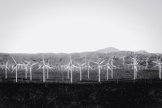 wind turbine in the desert with mountain background in black and white by Timmy333