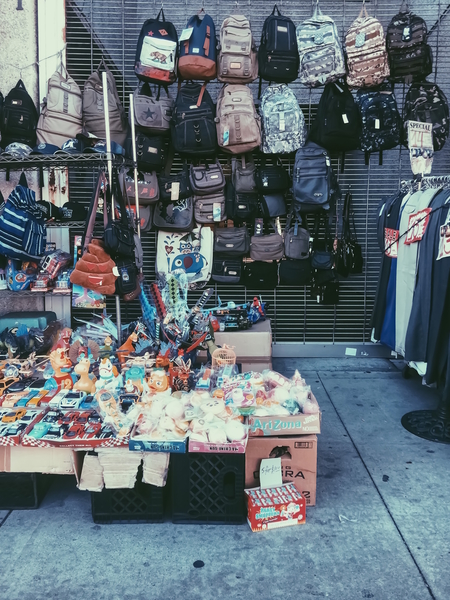 backpack and toy shop on the footpath by Timmy333