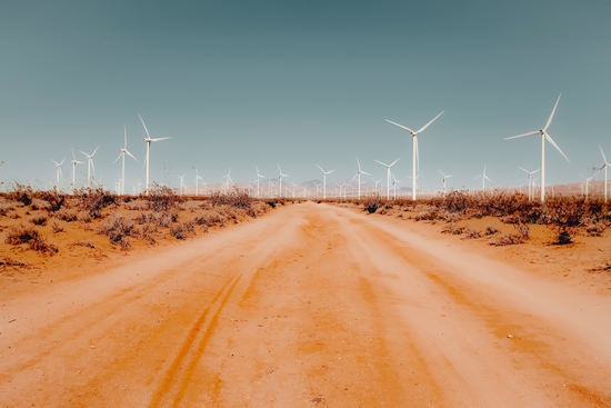 Wind turbine in the desert with sandy road at Kern County California USA by Timmy333