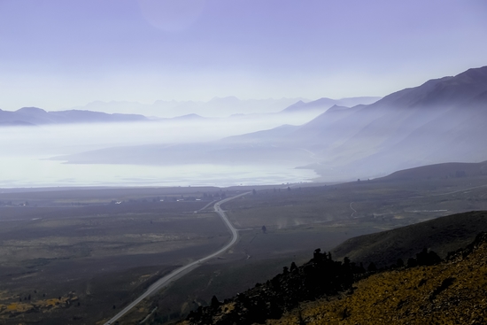 road with foggy sky and mountains scenic in California by Timmy333