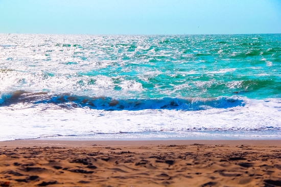 sandy beach with blue water and blue sky in summer by Timmy333