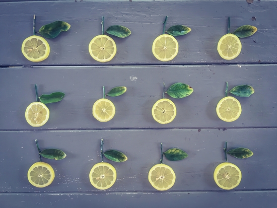 pieces of lemon on the wooden table by Timmy333